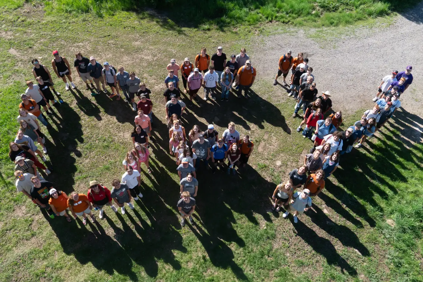Outdoors for Youth campers standing in formation to spell OFY, seen from above
